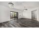 Spacious living area with modern flooring, a stylish chandelier, and sliding door access to the balcony at 15225 N 100Th St # 2210, Scottsdale, AZ 85260