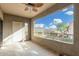 Inviting patio with ample space, featuring a ceiling fan, scenic outdoor view, and convenient access door at 15225 N 100Th St # 2210, Scottsdale, AZ 85260