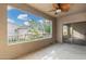 Spacious outdoor patio featuring a ceiling fan and sliding glass door with scenic neighborhood views at 15225 N 100Th St # 2210, Scottsdale, AZ 85260