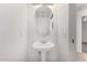 Neat powder room with pedestal sink, toilet, mirror, and light fixture at 15225 N 100Th St # 2210, Scottsdale, AZ 85260