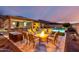 Inviting backyard featuring a firepit, pool, outdoor kitchen, and ample seating for entertaining at 15936 W Bonitos Dr, Goodyear, AZ 85395