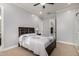 Well-lit bedroom with bed, ceiling fan, and a glimpse into the walk-in closet at 15936 W Bonitos Dr, Goodyear, AZ 85395