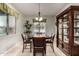 Formal dining room with elegant chandelier and decorative china cabinet at 15936 W Bonitos Dr, Goodyear, AZ 85395