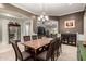 Elegant dining room with a large table, modern lighting, and seamless flow to the living area at 15936 W Bonitos Dr, Goodyear, AZ 85395