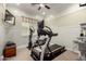Home gym features a treadmill, elliptical, and mounted TV, perfect for staying active indoors at 15936 W Bonitos Dr, Goodyear, AZ 85395