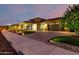 Beautiful home with a three-car garage, lush landscaping and paver driveway at 15936 W Bonitos Dr, Goodyear, AZ 85395