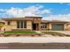 Charming single-story home with a manicured lawn, flower bed, and a two-car garage at 15936 W Bonitos Dr, Goodyear, AZ 85395