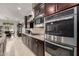 Elegant kitchen featuring stainless steel appliances and adjacent formal dining room at 15936 W Bonitos Dr, Goodyear, AZ 85395