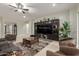 Spacious living room with a large TV and a large decorative cabinet at 15936 W Bonitos Dr, Goodyear, AZ 85395