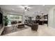 Open-concept living area with a large sectional sofa, a kitchen island, and backyard access at 15936 W Bonitos Dr, Goodyear, AZ 85395