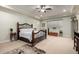 Bright main bedroom with tray ceilings, ceiling fan, and comfortable furnishings at 15936 W Bonitos Dr, Goodyear, AZ 85395
