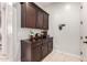 Mudroom featuring beautiful cabinets, decor, and access to the rest of the house at 15936 W Bonitos Dr, Goodyear, AZ 85395