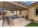 Outdoor kitchen with stainless steel grill, tile counters, barstool seating, and a backyard pergola at 15936 W Bonitos Dr, Goodyear, AZ 85395