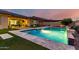 Luxury backyard with a pool, spa, grassy area, and covered patio, perfect for outdoor enjoyment at 15936 W Bonitos Dr, Goodyear, AZ 85395