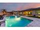 Beautiful backyard showcasing a pool with water features, an outdoor kitchen, and lush landscaping at 15936 W Bonitos Dr, Goodyear, AZ 85395