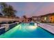 Backyard pool featuring water features, outdoor kitchen, and dining area, ideal for entertaining at 15936 W Bonitos Dr, Goodyear, AZ 85395