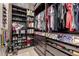 Well-organized walk-in closet with custom shelving, drawers, and ample storage space at 15936 W Bonitos Dr, Goodyear, AZ 85395