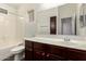 This bathroom features white countertops, a tub and shower combo, and dark wooden cabinets at 17150 N 23Rd St # 249, Phoenix, AZ 85022