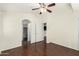 This bedroom features wood flooring, a ceiling fan, an archway, and a closet at 17150 N 23Rd St # 249, Phoenix, AZ 85022