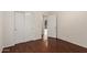 This bedroom features wood flooring, white walls, a closet, and an entryway at 17150 N 23Rd St # 249, Phoenix, AZ 85022