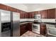 Modern kitchen with stainless steel appliances and dark wood cabinetry at 17150 N 23Rd St # 249, Phoenix, AZ 85022