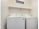 This laundry room features a stacked washer and dryer and a small window at 17150 N 23Rd St # 249, Phoenix, AZ 85022