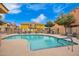 Community pool area with lounge chairs and seating under a sunny blue sky at 17150 N 23Rd St # 249, Phoenix, AZ 85022