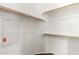 This walk-in closet features wood flooring, white walls, and lots of shelves for storage at 17150 N 23Rd St # 249, Phoenix, AZ 85022