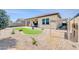 Stunning backyard featuring artificial turf, desert landscaping, and a covered patio area at 18837 N Cook Dr, Maricopa, AZ 85138