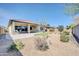 Serene backyard with pavers, patio, desert landscaping, and privacy fencing at 18837 N Cook Dr, Maricopa, AZ 85138