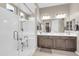 Bright bathroom with a glass enclosed walk-in shower, and dual sinks at 18837 N Cook Dr, Maricopa, AZ 85138
