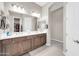 Bathroom featuring dual sinks with a large mirror and neutral color palette at 18837 N Cook Dr, Maricopa, AZ 85138