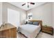 Bedroom featuring neutral walls, ceiling fan, and modern furnishings at 18837 N Cook Dr, Maricopa, AZ 85138