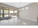 Bright dining space with sliding doors, tiled floor, and views of the brick-paved backyard at 18837 N Cook Dr, Maricopa, AZ 85138