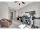Flex room featuring a ceiling fan, a leather chair, and an exercise bike at 18837 N Cook Dr, Maricopa, AZ 85138