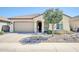 Charming single-story home boasts desert landscaping, a tile roof, and an attached two-car garage at 18837 N Cook Dr, Maricopa, AZ 85138
