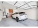 Spacious three car garage with epoxy flooring and custom cabinets for ample storage at 18837 N Cook Dr, Maricopa, AZ 85138