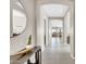 Inviting hallway featuring tiled flooring, neutral walls, arched doorways, and decorative accents at 18837 N Cook Dr, Maricopa, AZ 85138