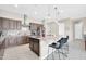 Open kitchen design with center island, pendant lights, and stainless-steel appliances at 18837 N Cook Dr, Maricopa, AZ 85138