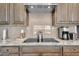 Close-up of the kitchen featuring granite countertops, a subway tile backsplash, and stainless-steel appliances at 18837 N Cook Dr, Maricopa, AZ 85138