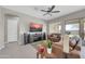 Comfortable living area featuring neutral tile flooring, a ceiling fan, and ample space for furniture at 18837 N Cook Dr, Maricopa, AZ 85138