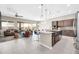Open-concept living space with seamless flow between the kitchen, living room, and dining area at 18837 N Cook Dr, Maricopa, AZ 85138