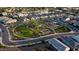 An aerial view of a neighborhood featuring a beautiful green park with a playground, walking trails, and picnic spots at 2330 E Lieber Pl, Phoenix, AZ 85024