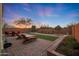 Landscaped backyard with a large patio, artificial turf, and desert views at 2330 E Lieber Pl, Phoenix, AZ 85024