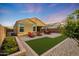 Expansive backyard featuring desert landscaping, artificial turf, and a covered patio at 2330 E Lieber Pl, Phoenix, AZ 85024