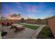 Desert backyard with patio, artificial turf, and desert landscaping at 2330 E Lieber Pl, Phoenix, AZ 85024