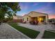 Beautiful backyard with artificial turf, brick pavers, patio, and outdoor seating, perfect for entertaining or relaxing at 2330 E Lieber Pl, Phoenix, AZ 85024