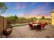 Well-maintained backyard featuring a brick patio, artificial turf, and desert landscaping at 2330 E Lieber Pl, Phoenix, AZ 85024