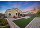 Beautiful backyard showcasing patio, desert landscaping, and artificial turf at 2330 E Lieber Pl, Phoenix, AZ 85024
