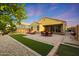Spacious backyard with manicured landscaping, artificial turf, and a covered patio area at 2330 E Lieber Pl, Phoenix, AZ 85024